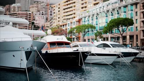 View of boats docked in the Monaco Marina with the skyline of the city on the background