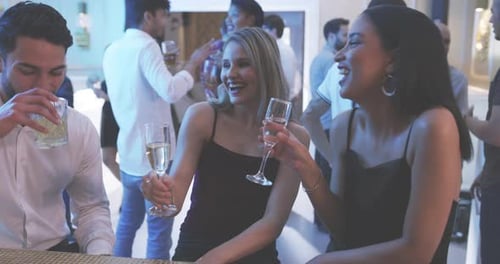 Stylish Friends Celebrating with Drinks at Lively Party
