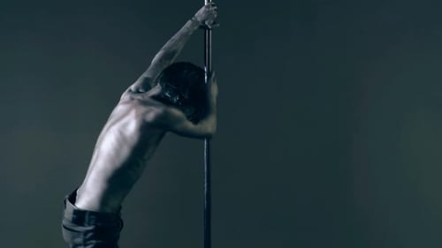 Pole Dancer Guy Does Gymnastic Exercises on Pole Dance Pole Dancing for Slim Fitness Body