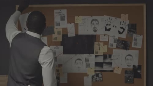 African American Detective Examining Evidence Board at Night Office