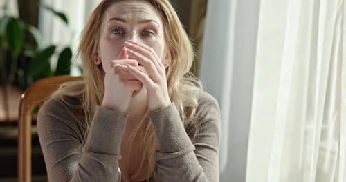 Distressed Fair-Haired Woman Indoors Smiles