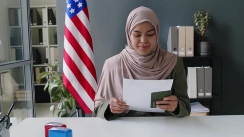 Portrait of Muslim Visa Officer in Hijab Working in US Embassy
