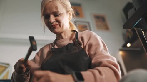 Craftswoman Using Hammer in Her Workshop