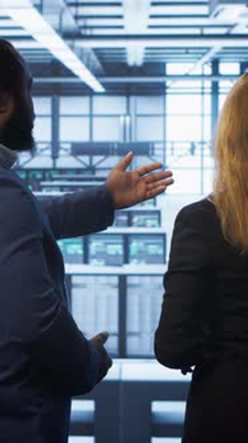 Vertical Video Data Center Engineer Presenting Equipment to Inspector Supervising Operations