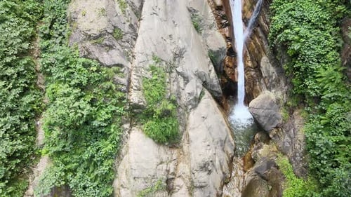 Aerial View of a Tranquil Waterfall in Nature