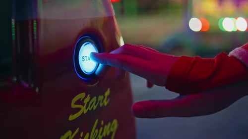 Hand Pushing Start Button at Arcade Game Machine Closeup Funfair Girl Playing