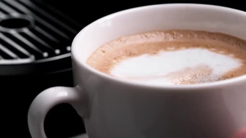 Adding a Sugar Into a Cup with a Homemade Fresh Cappuccino Coffee