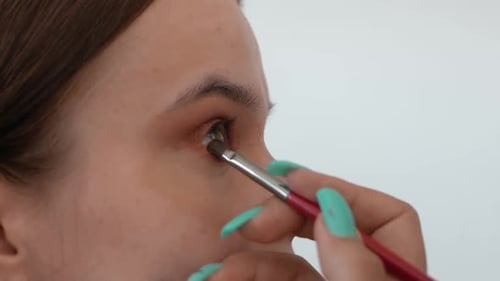 Makeup Artist Applying Makeup to Model's Face Close Up View