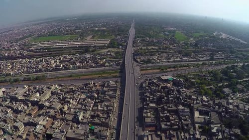 Aerial view over the Traffic passes at junction with canal, bridge highway