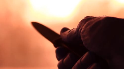 Dangerous Knife in the Darkness and Person Holding it