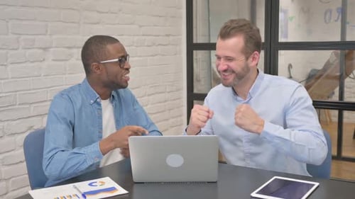 Excited Business People Celebrating Success in Office