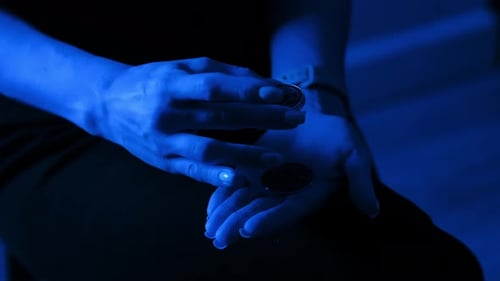 Woman's Hands Holding Crypto Coins in Blue Light