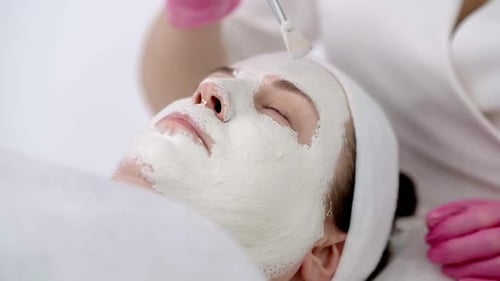 Skincare Expert Applying a Nourishing Face Mask to Her Client with Brush for Specific Skin Problems
