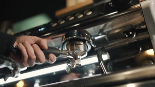 Portafilter Inserted into Commercial Stainless Steel Espresso Machine