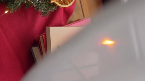 Christmas Books with Candle and Evergreen Decoration