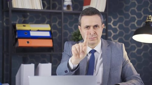 Office worker waving his finger in negative and no.