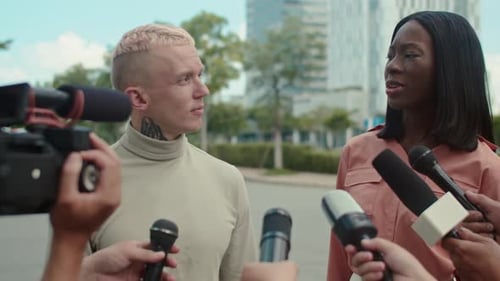 Two People Giving Press Interview Outdoors