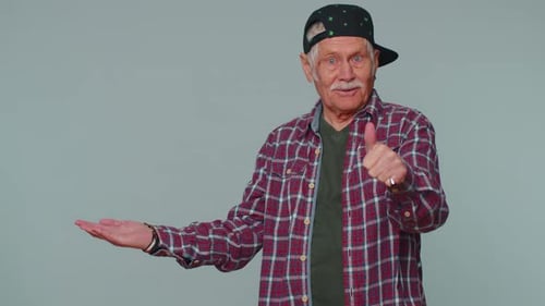 Senior Man Pointing Empty Place Advertising Area for Commercial Text Copy Space for Goods Promotion