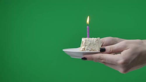 Close Up on Green Chromakey Background A Woman Can Be Seen Holding Her Hands She is Holding a Piece