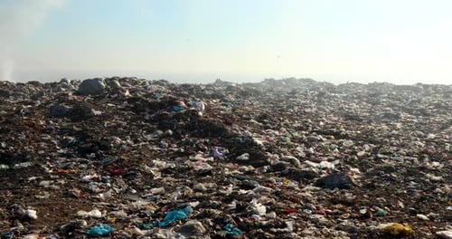 Burning trash piles in landfill