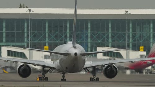 Airplane on Taxiway Rear View