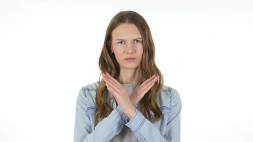 Young Woman Expressing No with Crossed Arms