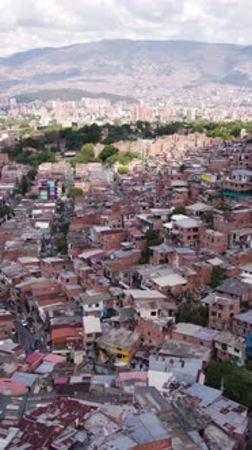 Aerial view of Comuna 13 showing colorful houses and Andes Mountains in Medellin, Colombia