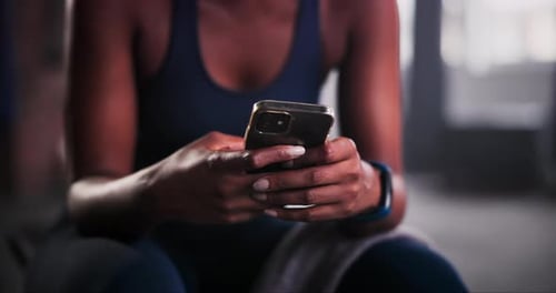 Woman, hands and phone in fitness for communication, social media or typing on sports app at gym