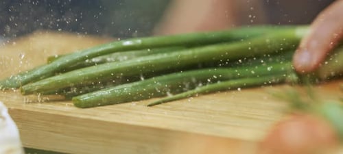 Green onions falling on wood