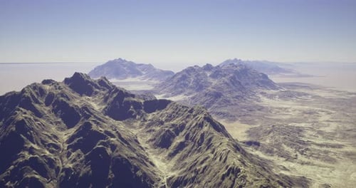 Majestic Mountain Range Under Clear Sky with Distant Peaks Visible