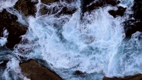 AERIAL: Angry waves crashing on rocks at North Bondi in Sydney Australia.