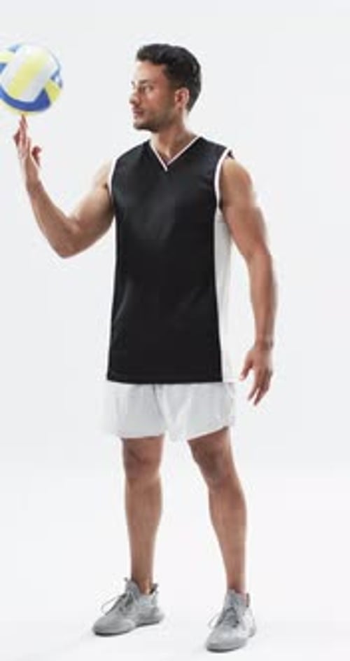 Athletic Young Adult Spinning Volleyball on Finger