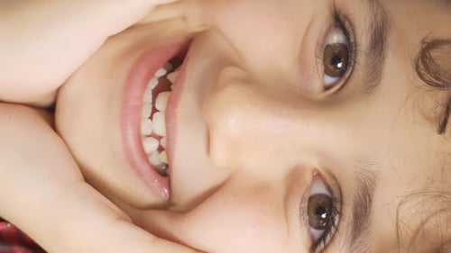 Vertical Video of Happy boy winking looking at camera.