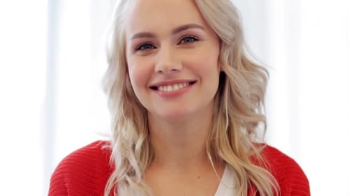 Smiling Woman in Red Sweater Looking at Camera