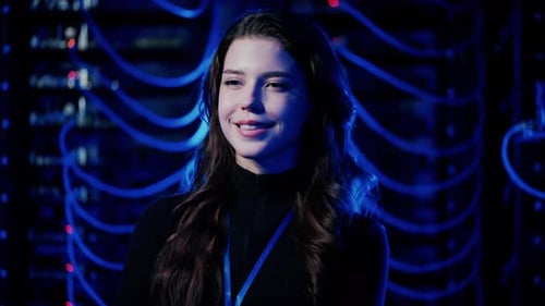 Young Woman Smiling in Dark Server Room