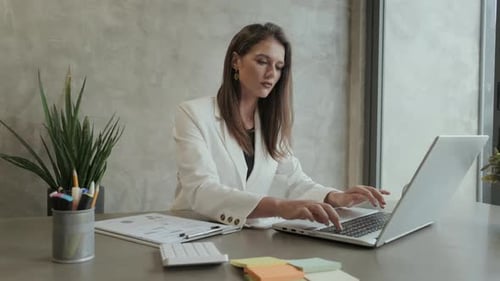 Business Woman Working on Laptop in Office