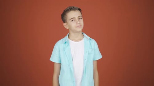 Child Posing Against a Solid Backdrop