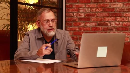 Man at Laptop Participating in Video Conference