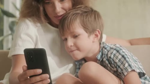 Mother and Son Using Smartphone Together at Home