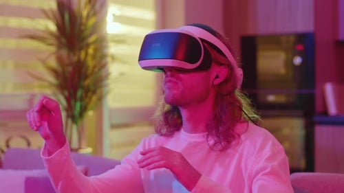 Young Adult Using VR Headset in a Colorful Room