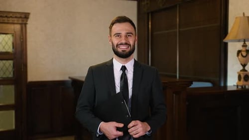 Professional Hotel Manager Welcoming Guests with a Friendly Smile