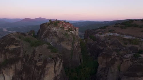 Aerial view of monasteries and rock formations at sunrise, Greece.