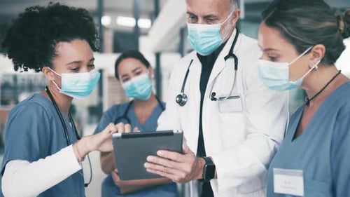 Medical Team Works Together Using Tablet Technology