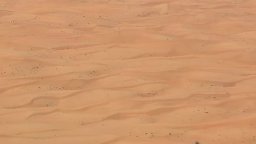 Desert dunes seen from the sky in sideway flight