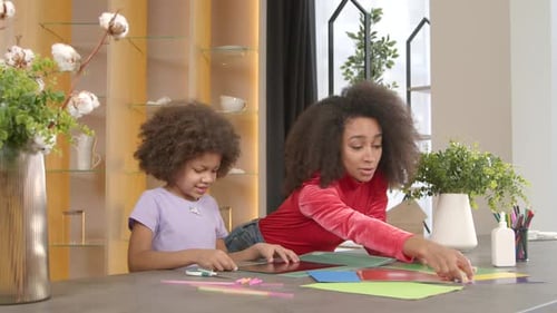 Little Black Girl and Mother Preparing Craft Greeting Cards From Colored Paper