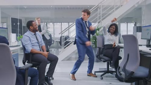 Young Happy Business Manager Wearing a Suit and Tie Dancing and Giving High Fives in the Office. Ce