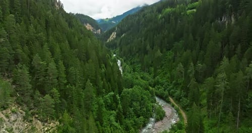 Drone Flies Over Green Picturesque Valley with Mountains in the Background High Mountains Famous