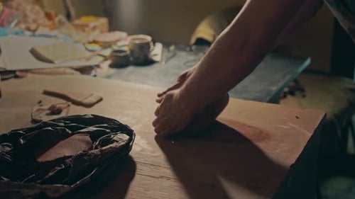 Artist Works Clay in Cozy Pottery Studio