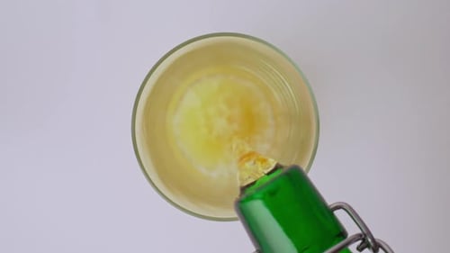 Top Down View: Beer Pouring into Glass