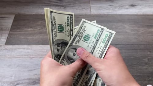 Hands Count Stack of United States Hundred Dollar Bills